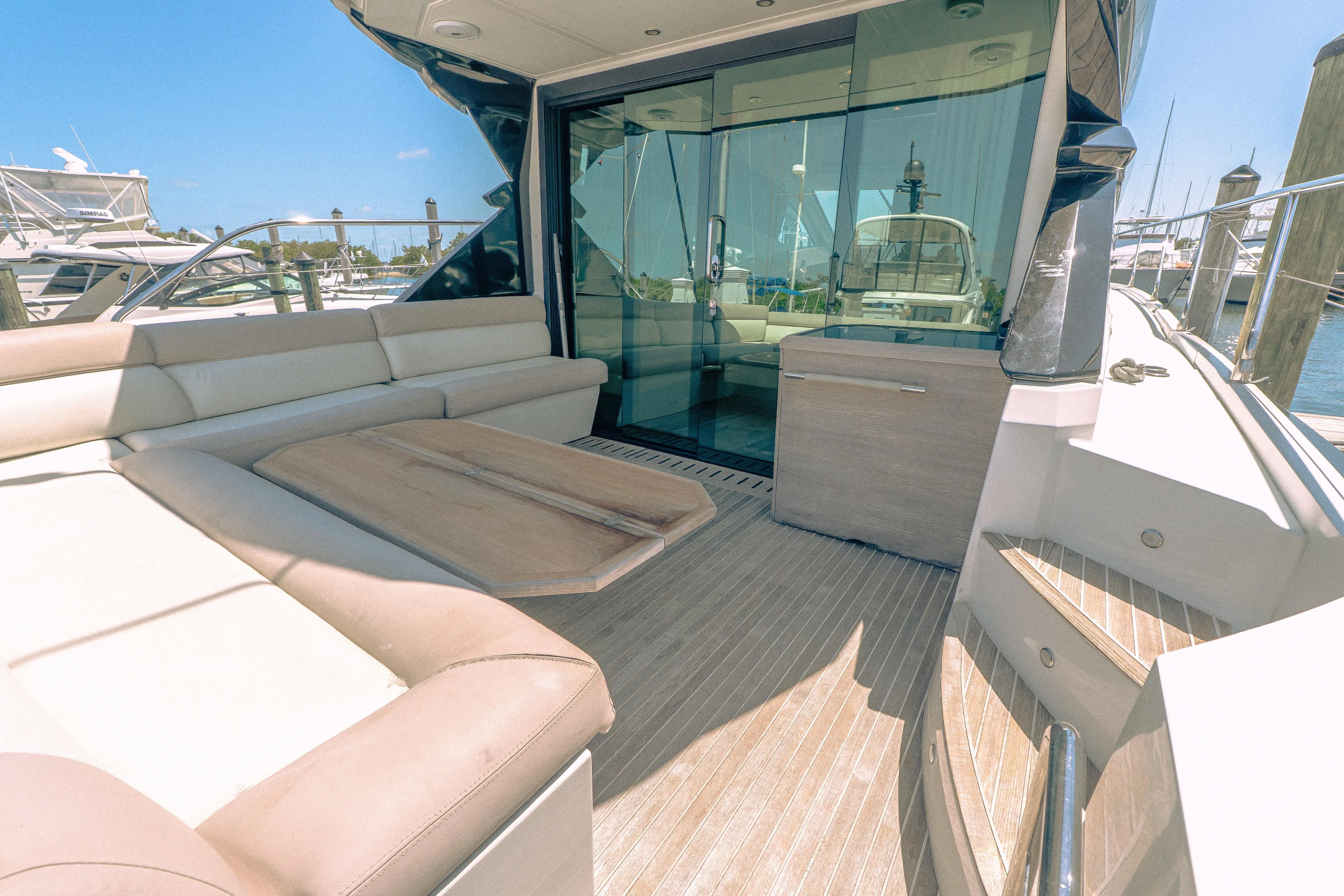 Gracia Yacht Photos Pics 2019 Beneteau Gran Turismo 50 yacht with spacious outdoor seating and glass doors.