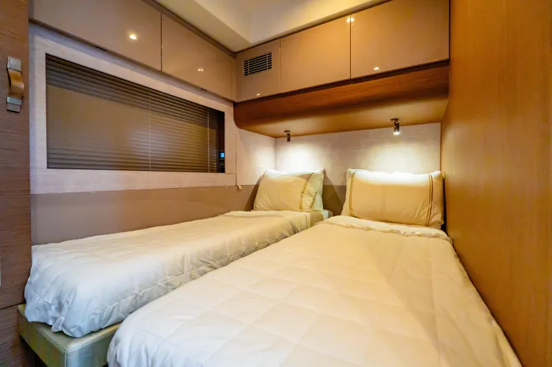 Gracia Yacht Photos Pics Twin cabin interior of 2019 Beneteau Gran Turismo 50 yacht, featuring modern design and cozy bedding.
