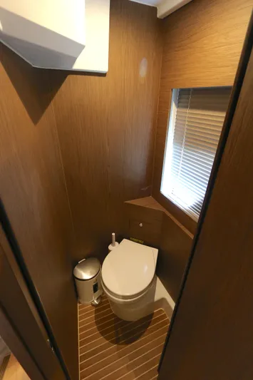 Gracia Yacht Photos Pics 2019 Beneteau Gran Turismo 50 yacht bathroom with modern wood paneling and compact design.