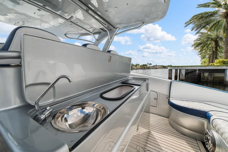  Yacht Photos Pics Luxury 2017 Midnight Express 43 Open yacht interior with sink, palm trees, and waterfront view.