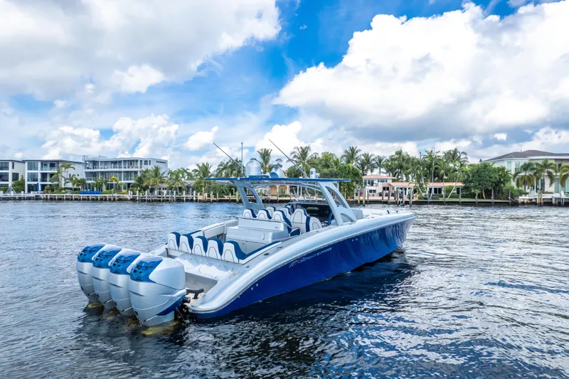  Yacht Photos Pics 2017 Midnight Express 43 Open boat on water, with palm trees and houses in the background.