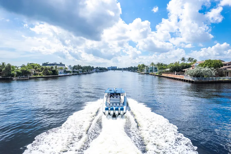  Yacht Photos Pics 2017 Midnight Express 43 Open boat cruising on a scenic waterway under a blue sky.