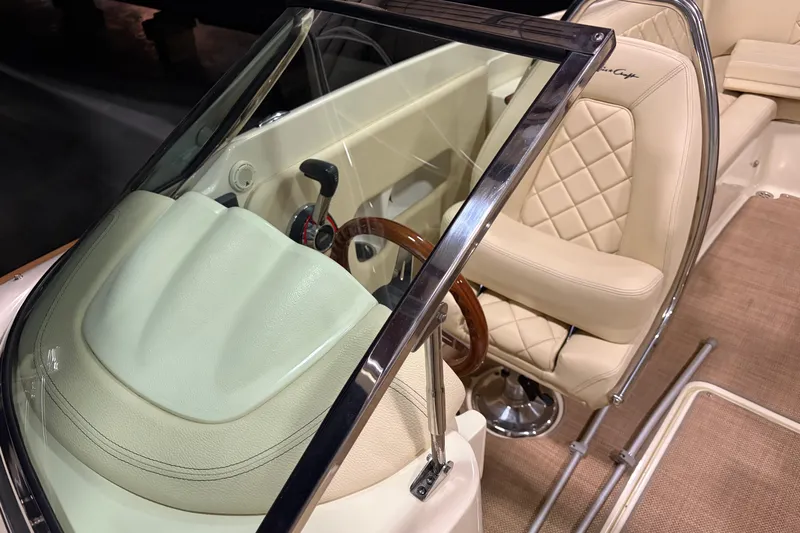 Yacht Photos Pics 2020 Chris-Craft Launch 28 GT interior with leather seats and wooden steering wheel.
