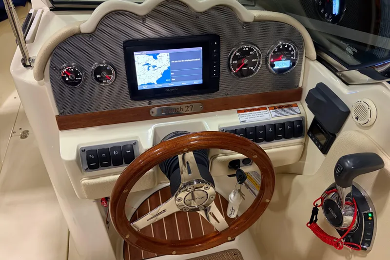  Yacht Photos Pics 2020 Chris-Craft Launch 28 GT dashboard with GPS, gauges, and wooden steering wheel.