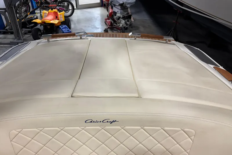  Yacht Photos Pics 2020 Chris-Craft Launch 28 GT boat interior with quilted upholstery in a garage setting.