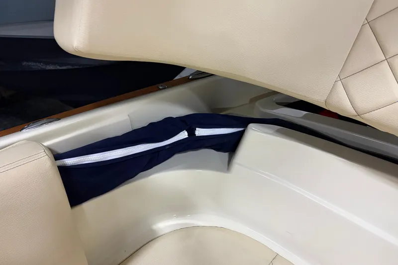  Yacht Photos Pics 2020 Chris-Craft Launch 28 GT interior storage compartment with beige seating and blue cover.