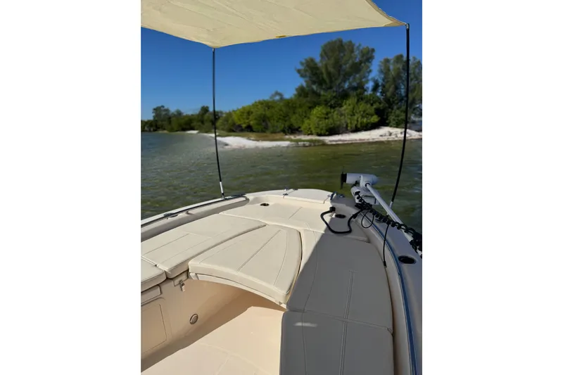  Yacht Photos Pics 2023 Grady-White 251 Coastal Explorer boat near a scenic shoreline.