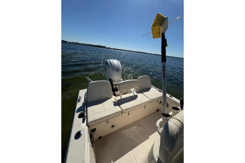  Yacht Photos Pics 2023 Grady-White 251 Coastal Explorer boat on calm water, featuring a clean deck and seating.