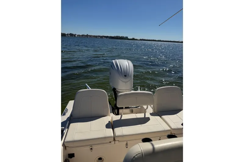  Yacht Photos Pics 2023 Grady-White 251 Coastal Explorer boat on water, featuring rear seating and outboard motor.