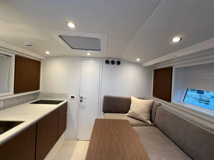 Stanislas Michel Yacht Photos Pics Modern interior of 2025 Itama 45 RS yacht with sleek kitchen and cozy seating area.
