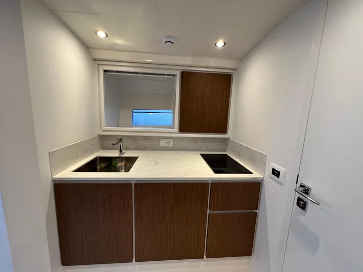 Stanislas Michel Yacht Photos Pics Modern kitchen area in 2025 Itama 45 RS yacht with sleek wood cabinetry.
