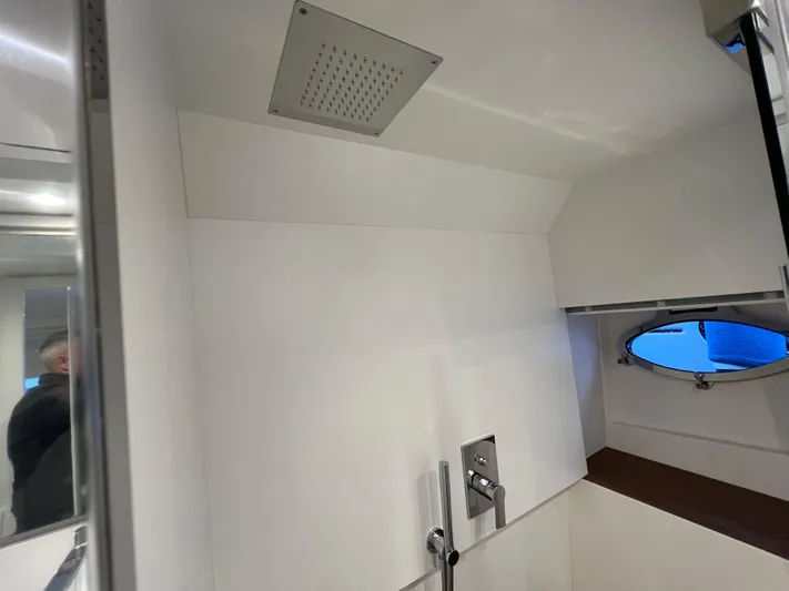 Stanislas Michel Yacht Photos Pics Interior of 2025 Itama 45 RS yacht bathroom with modern fixtures and porthole window.