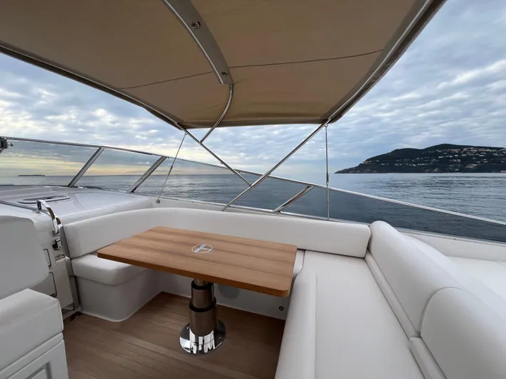 Stanislas Michel Yacht Photos Pics Luxury Itama 45 RS yacht interior with ocean view, featuring elegant seating and wooden table, 2025 model.