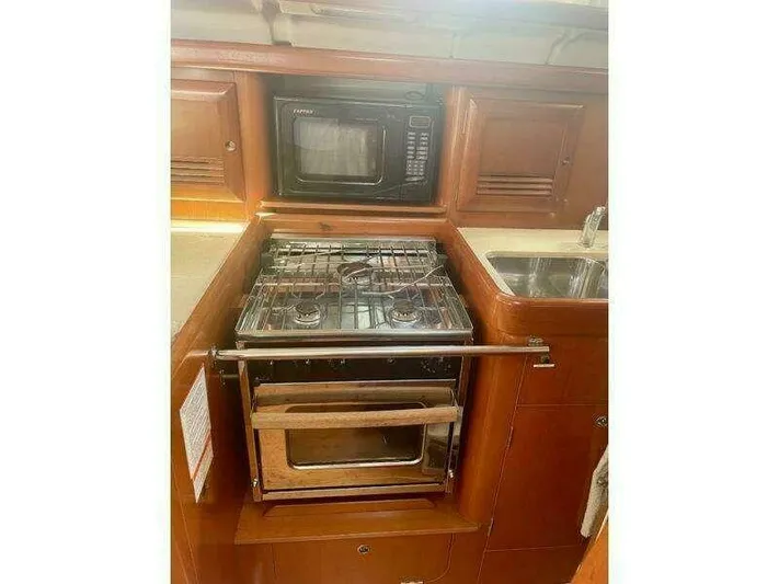  Yacht Photos Pics Galley kitchen in 2007 Beneteau 423 yacht with stove, oven, and microwave.