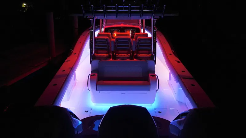  Yacht Photos Pics 2026 Mag Bay 43 CC boat with vibrant red and blue interior lighting at night.