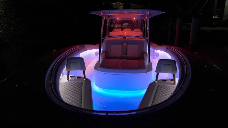  Yacht Photos Pics 2026 Mag Bay 43 CC boat with vibrant interior lighting at night.