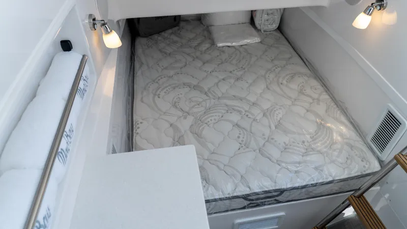  Yacht Photos Pics 2026 Mag Bay 43 CC cabin interior with cozy bed and modern lighting.