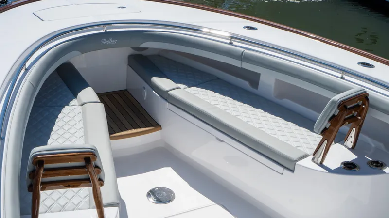  Yacht Photos Pics 2026 Mag Bay 43 CC boat interior with cushioned seating and wooden accents.