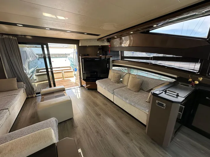  Yacht Photos Pics Luxurious interior of a 2013 Marquis 630 yacht with modern furnishings and large windows.