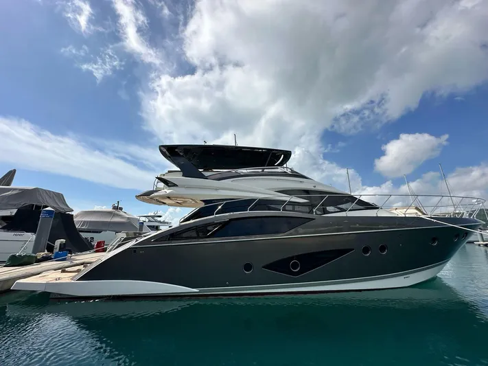  Yacht Photos Pics Luxury 2013 Marquis 630 yacht docked under a partly cloudy sky.