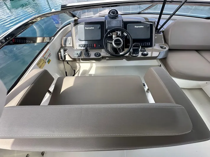  Yacht Photos Pics 2013 Marquis 630 yacht helm with dual Raymarine displays and leather seating.