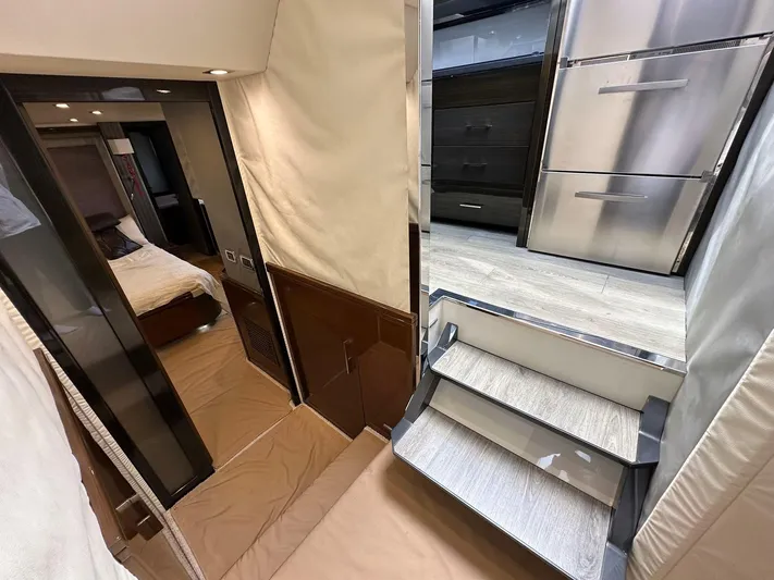  Yacht Photos Pics Interior of 2013 Marquis 630 yacht showing stairs, bedroom, and modern kitchen area.