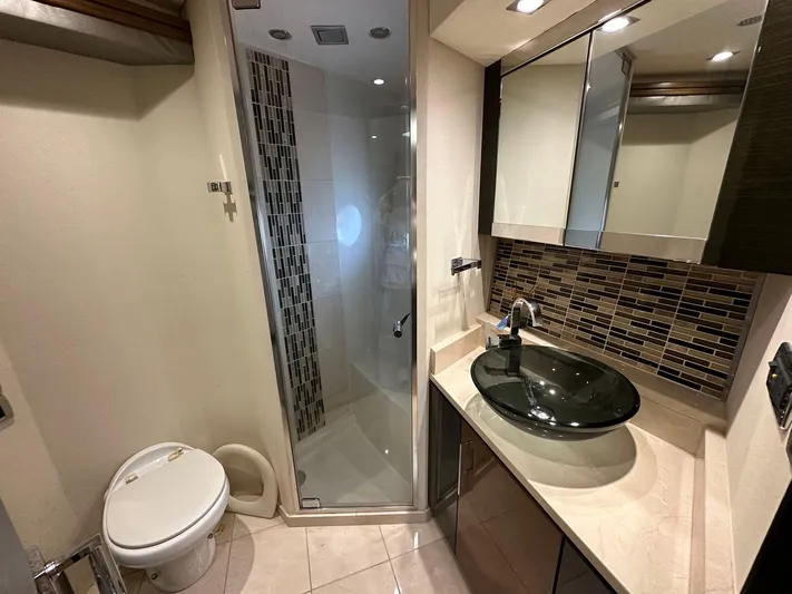  Yacht Photos Pics Luxurious bathroom in 2013 Marquis 630 yacht with modern fixtures and glass shower.