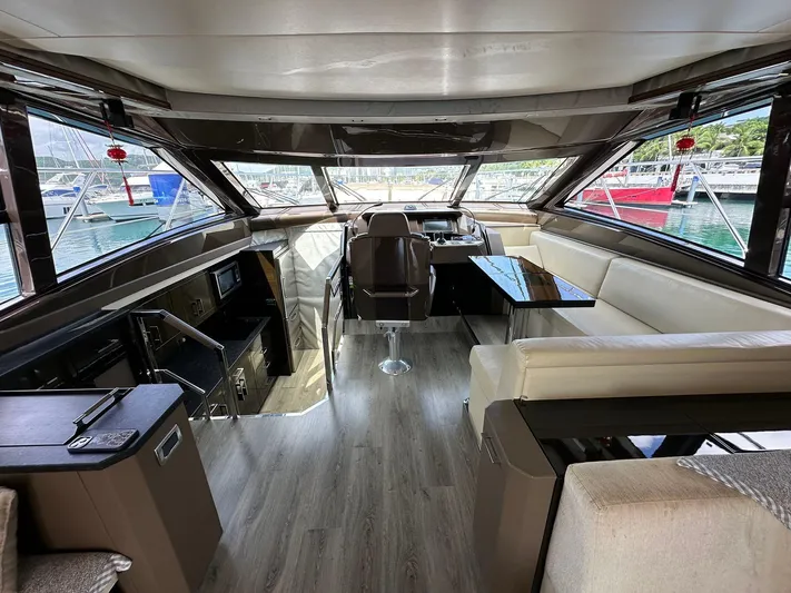  Yacht Photos Pics Luxurious interior of a 2013 Marquis 630 yacht with modern seating and panoramic windows.