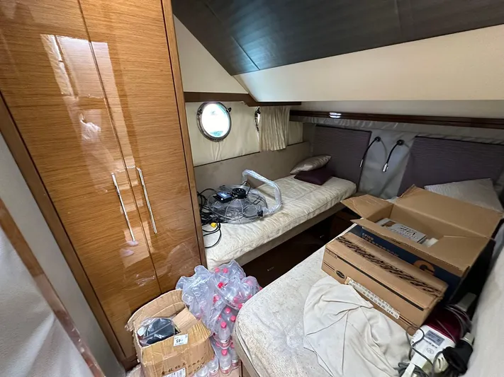  Yacht Photos Pics Cozy cabin interior of 2013 Marquis 630 yacht with twin beds and storage boxes.
