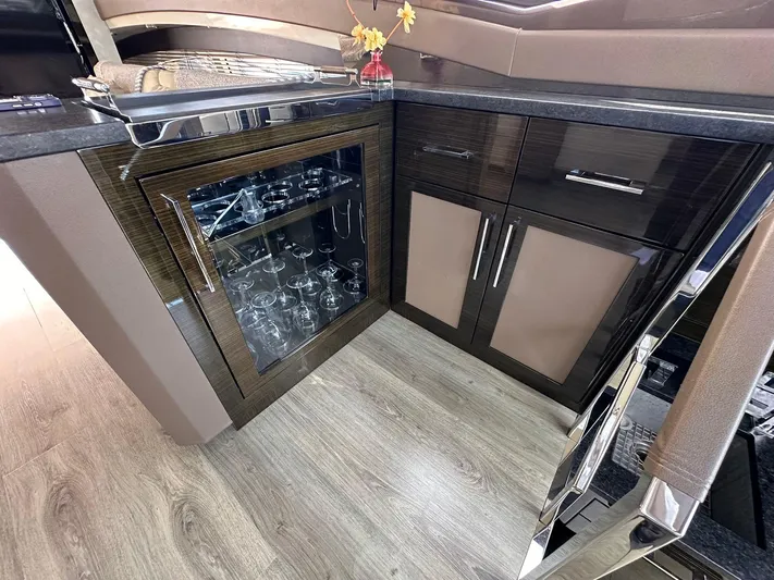  Yacht Photos Pics Luxurious interior of 2013 Marquis 630 yacht with glass cabinet and modern design.