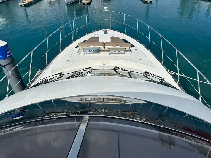  Yacht Photos Pics 2013 Marquis 630 yacht deck view with sun loungers, docked in marina.