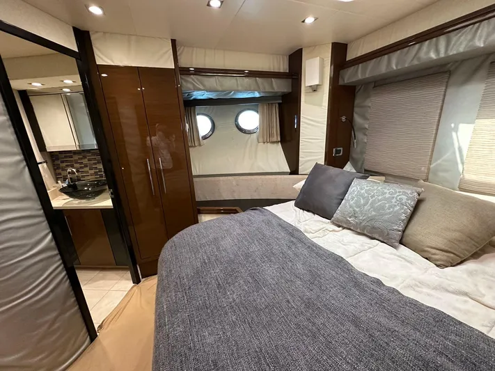  Yacht Photos Pics Luxurious 2013 Marquis 630 yacht bedroom with modern decor and porthole windows.