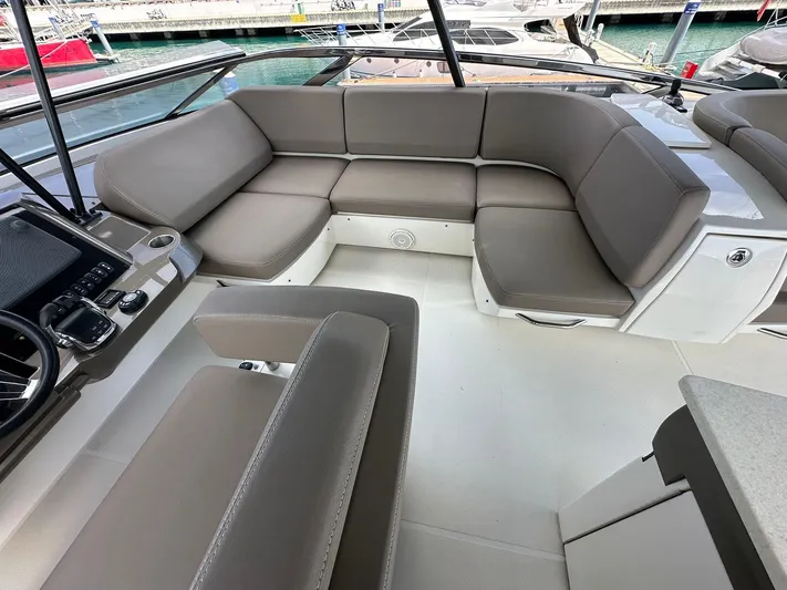  Yacht Photos Pics Luxurious seating area on a 2013 Marquis 630 yacht, featuring plush gray cushions.