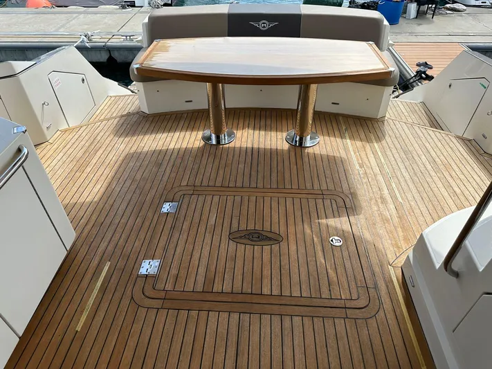  Yacht Photos Pics Luxurious 2013 Marquis 630 yacht deck with wooden flooring and elegant dining table.