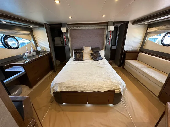  Yacht Photos Pics Luxurious bedroom interior of 2013 Marquis 630 yacht with elegant furnishings and ambient lighting.