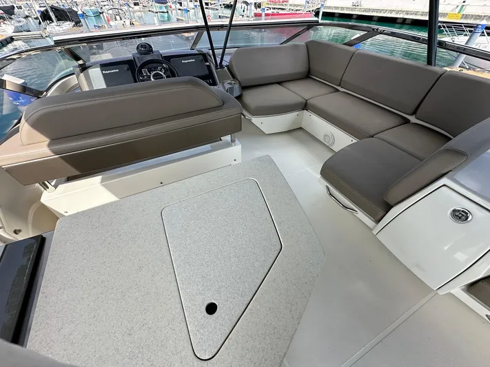  Yacht Photos Pics Luxurious 2013 Marquis 630 yacht interior with plush seating and modern helm.
