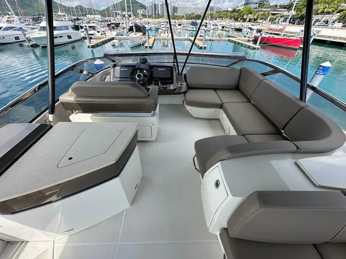  Yacht Photos Pics Luxurious 2013 Marquis 630 yacht interior with spacious seating in a marina setting.