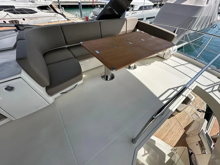 Yacht Photos Pics Luxurious seating area on 2013 Marquis 630 yacht with wooden table and marina view.