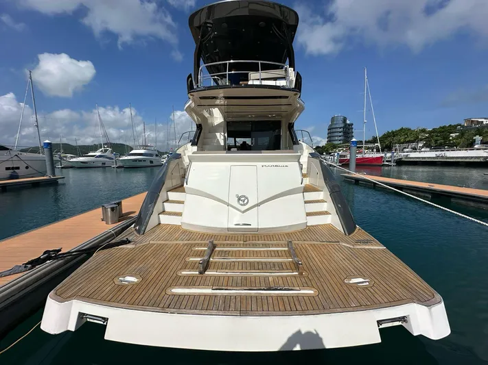  Yacht Photos Pics 2013 Marquis 630 yacht docked at marina, showcasing spacious deck and elegant design.