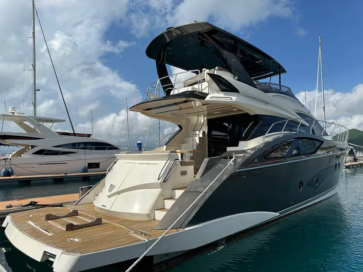  Yacht Photos Pics Luxurious 2013 Marquis 630 yacht docked at marina under clear skies.