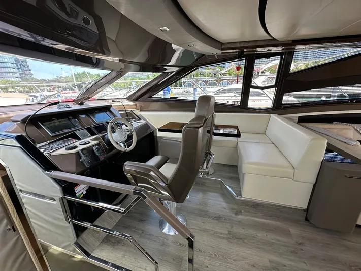  Yacht Photos Pics Luxurious interior of a 2013 Marquis 630 yacht with modern helm and seating area.