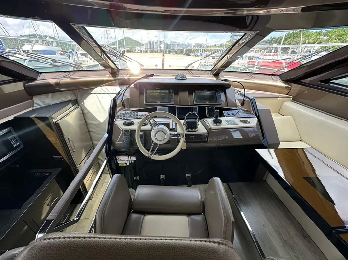  Yacht Photos Pics Luxurious 2013 Marquis 630 yacht cockpit with modern navigation controls and panoramic windows.