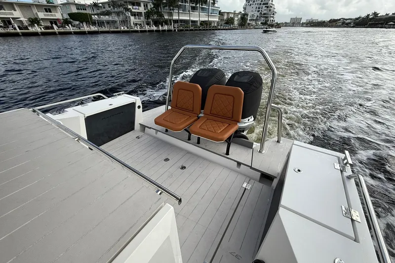 Abeona Yacht Photos Pics 2018 Axopar 37 Sport Cabin boat with dual seats and outboard motors on a waterway.
