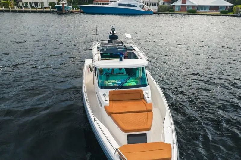 Abeona Yacht Photos Pics 2018 Axopar 37 Sport Cabin boat on water, featuring sleek design and orange seating.