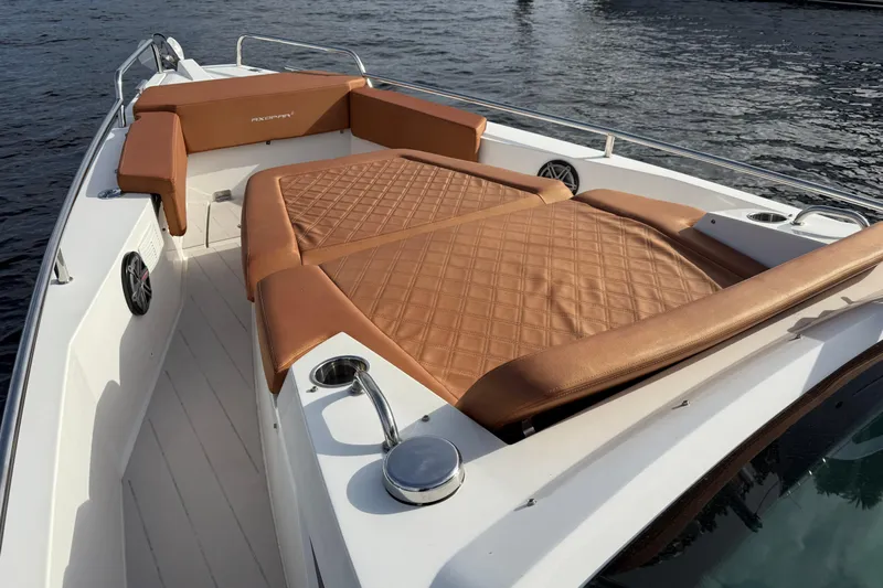 Abeona Yacht Photos Pics 2018 Axopar 37 Sport Cabin with tan leather seating on deck, docked on water.