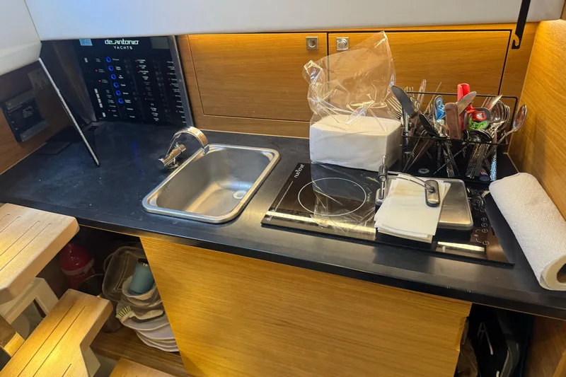  Yacht Photos Pics Compact kitchen area in 2022 De Antonio Yachts D42 Open, featuring sink and stove.