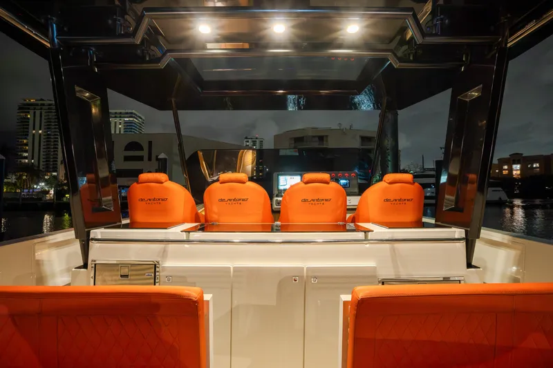  Yacht Photos Pics 2023 De Antonio Yachts D42 Open with illuminated cockpit and vibrant orange seating.