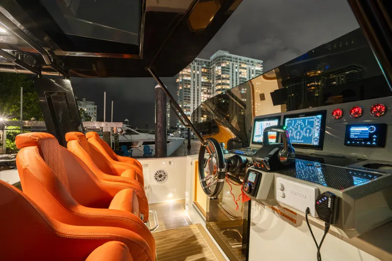  Yacht Photos Pics 2023 De Antonio Yachts D42 Open cockpit with orange seats and advanced navigation system.