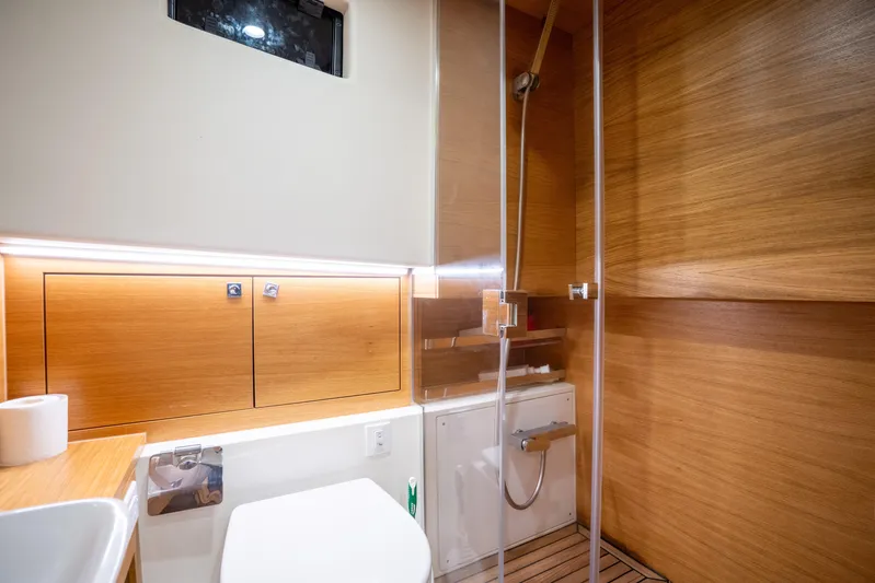  Yacht Photos Pics Luxurious bathroom interior of 2023 De Antonio Yachts D42 Open with wood accents and modern fixtures.