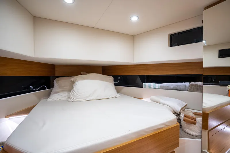  Yacht Photos Pics Luxurious cabin interior of 2023 De Antonio Yachts D42 Open, featuring a cozy bed and modern design.
